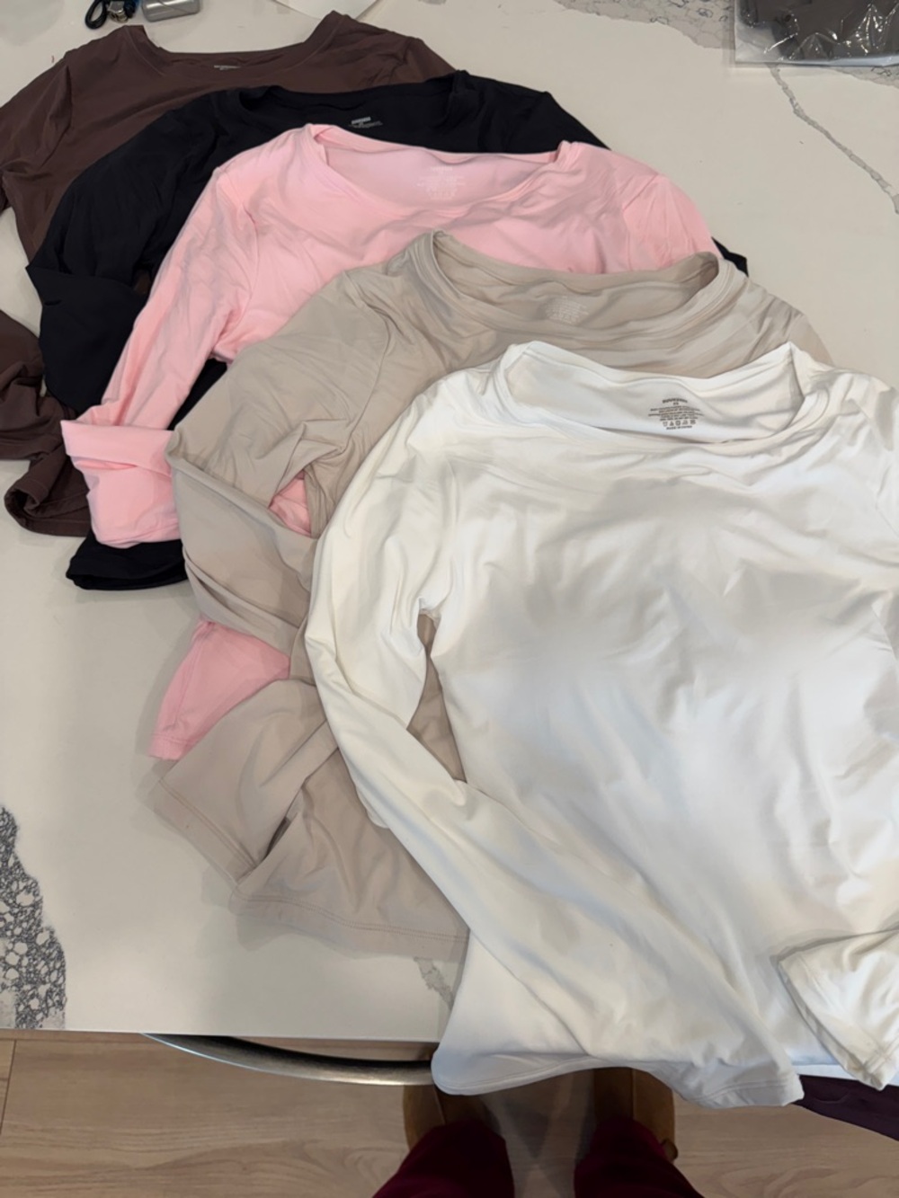 Stack of Women's Long Sleeve Crewneck Tops — White, Taupe, Pink, Black, Brown
